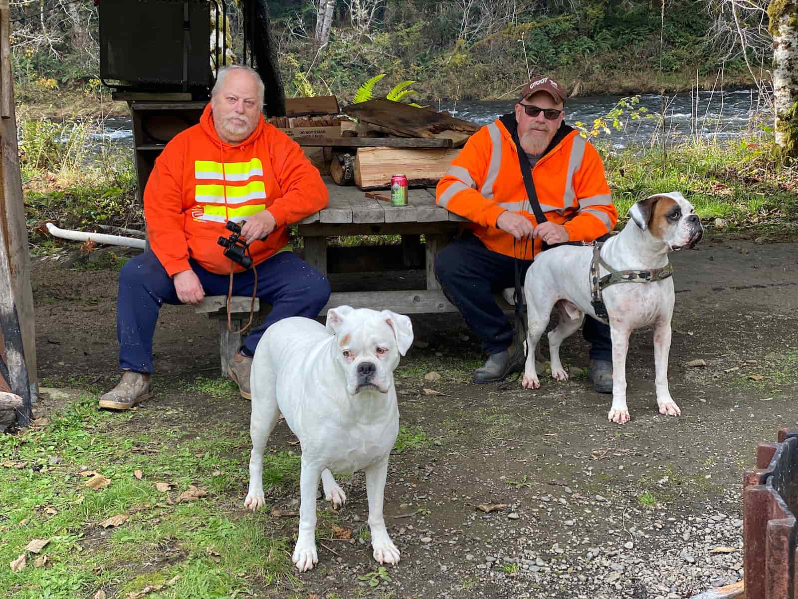 Dave and Jimmy Hahn with their dogs at a creek on the Olympic Peninsula